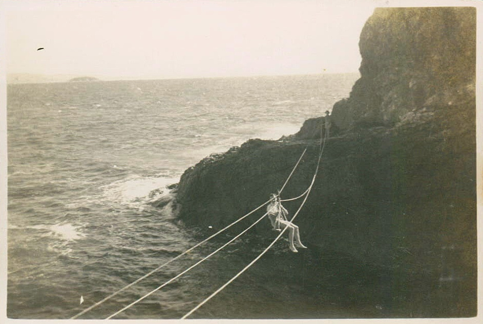 Visitor Gordon Bailey crosses to Bird Island on a flying fox, 1946