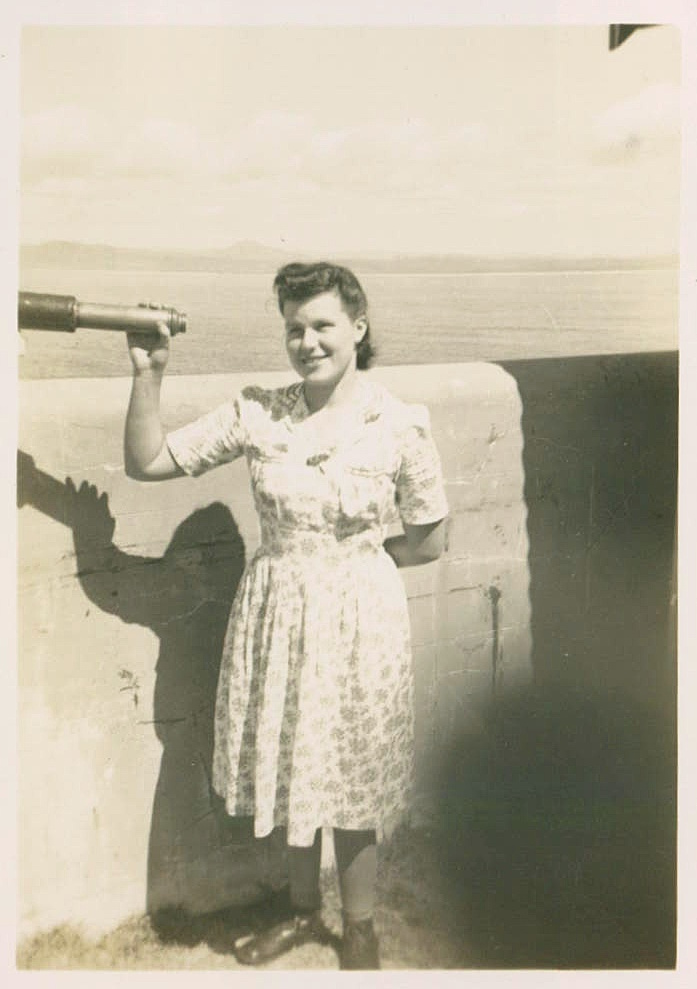 Beryl Duncan with telescope on South Solitary Island, 1946