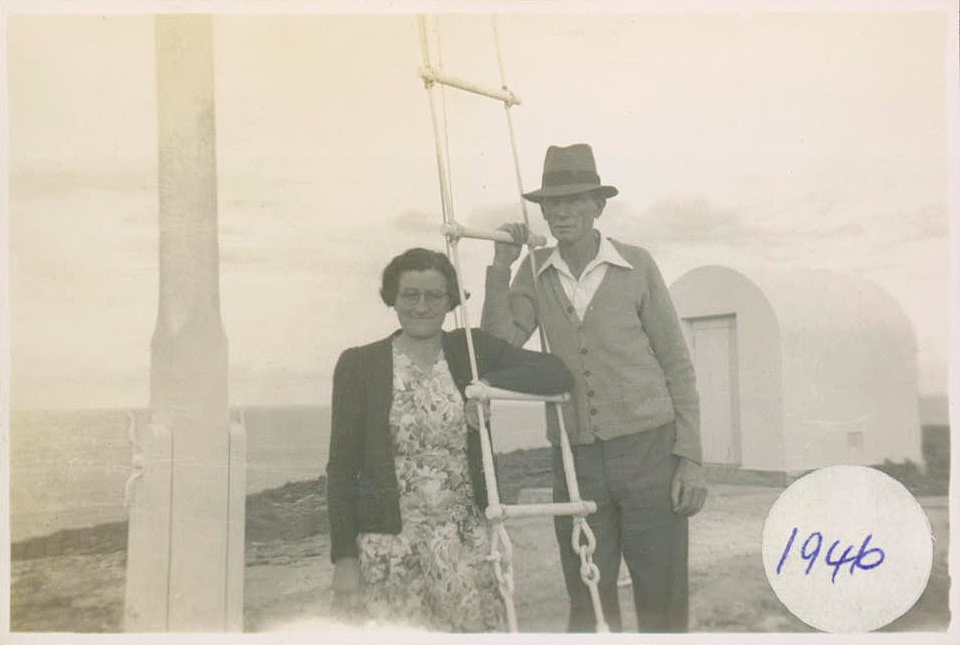 Jim and Ella Duncan at the flagpole on South Solitary Island, 1946