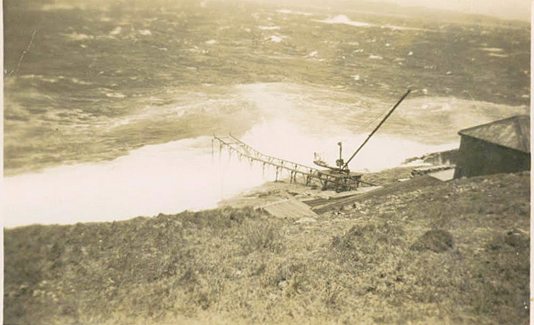 South Solitary Island jetty with crane above a rough sea, 1946