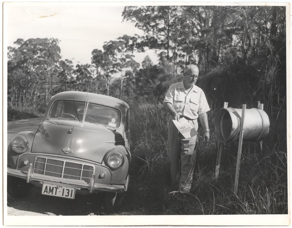 Jack Gerard putting Tasma Theatre flyers in mailboxes c.1950