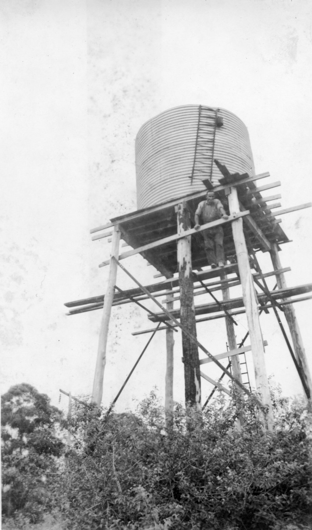 Chris Lewthwaite checking the water level in a tank off Englands Road, 1950