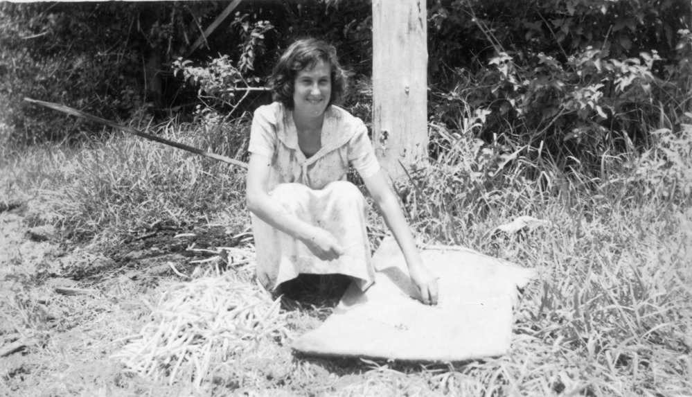 Noelene Lewthwaite lays out morning tea near the pumpkin patch off Englands Road, 1950