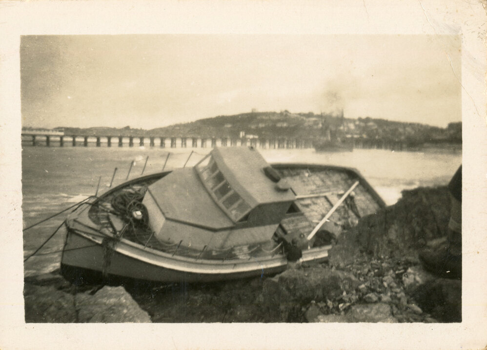 The Reliance Star rests against rocks on north wall after a cyclone, June 1950