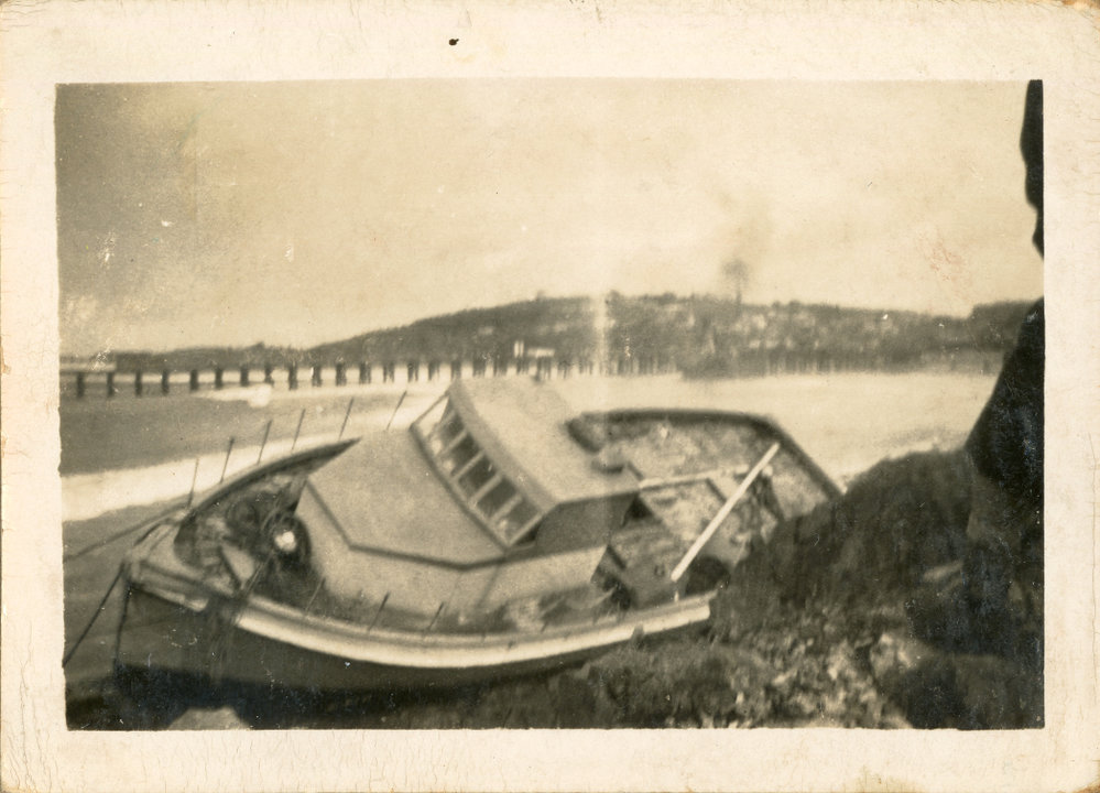 Local fisherman Syd Hardy's boat on rocks at Jetty Beach, 24 June 1950