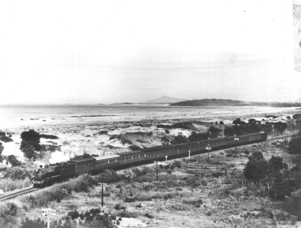 The railway line cuts through the sand dunes