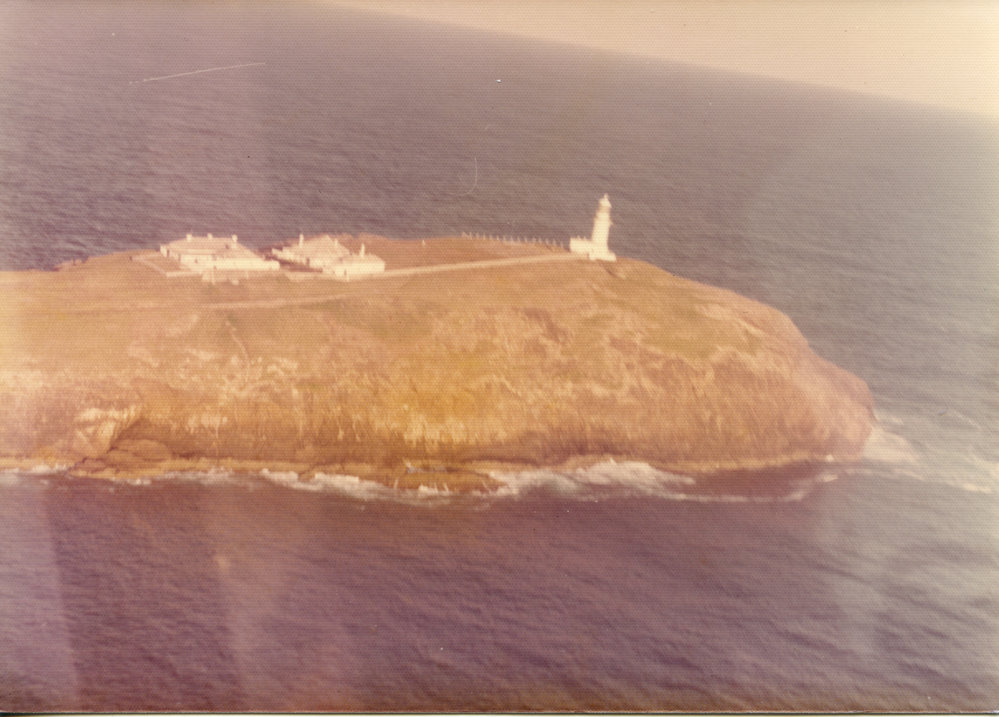 Helicopter view of South Solitary Island Lighthouse and Lightkeepers' Cottages, mid 1970s