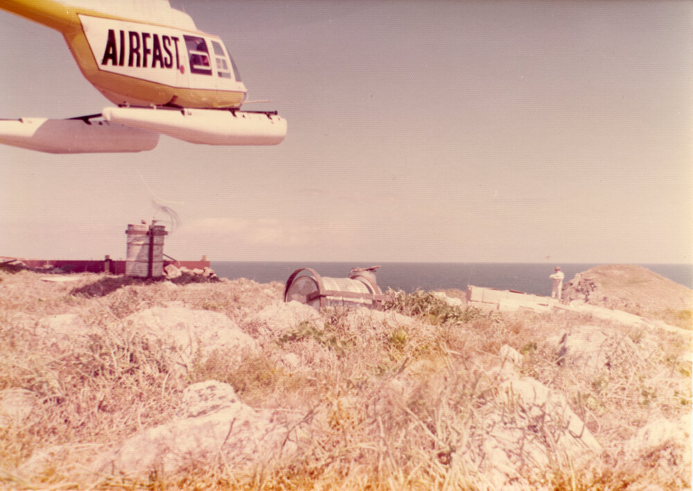 An Airfast helicopter delivers supplies to North Solitary Island, mid 1970s