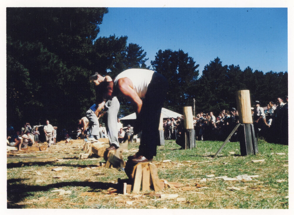 Harry Bailey wearing his suit pants in a woodchopping demonstration