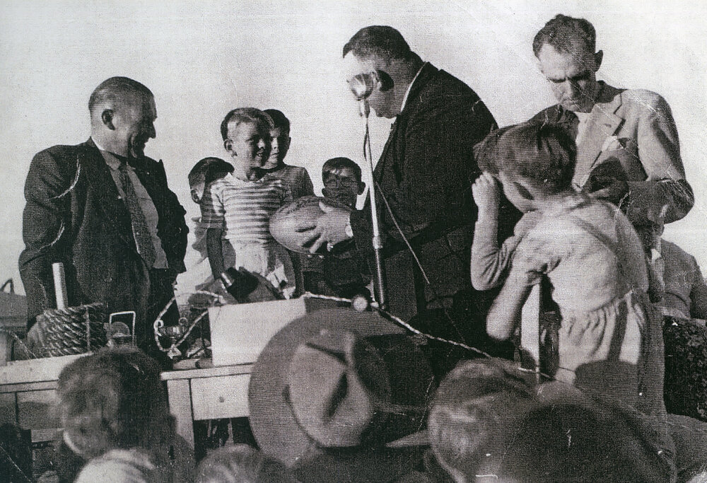 Harry Bailey and young players with a Rugby League football