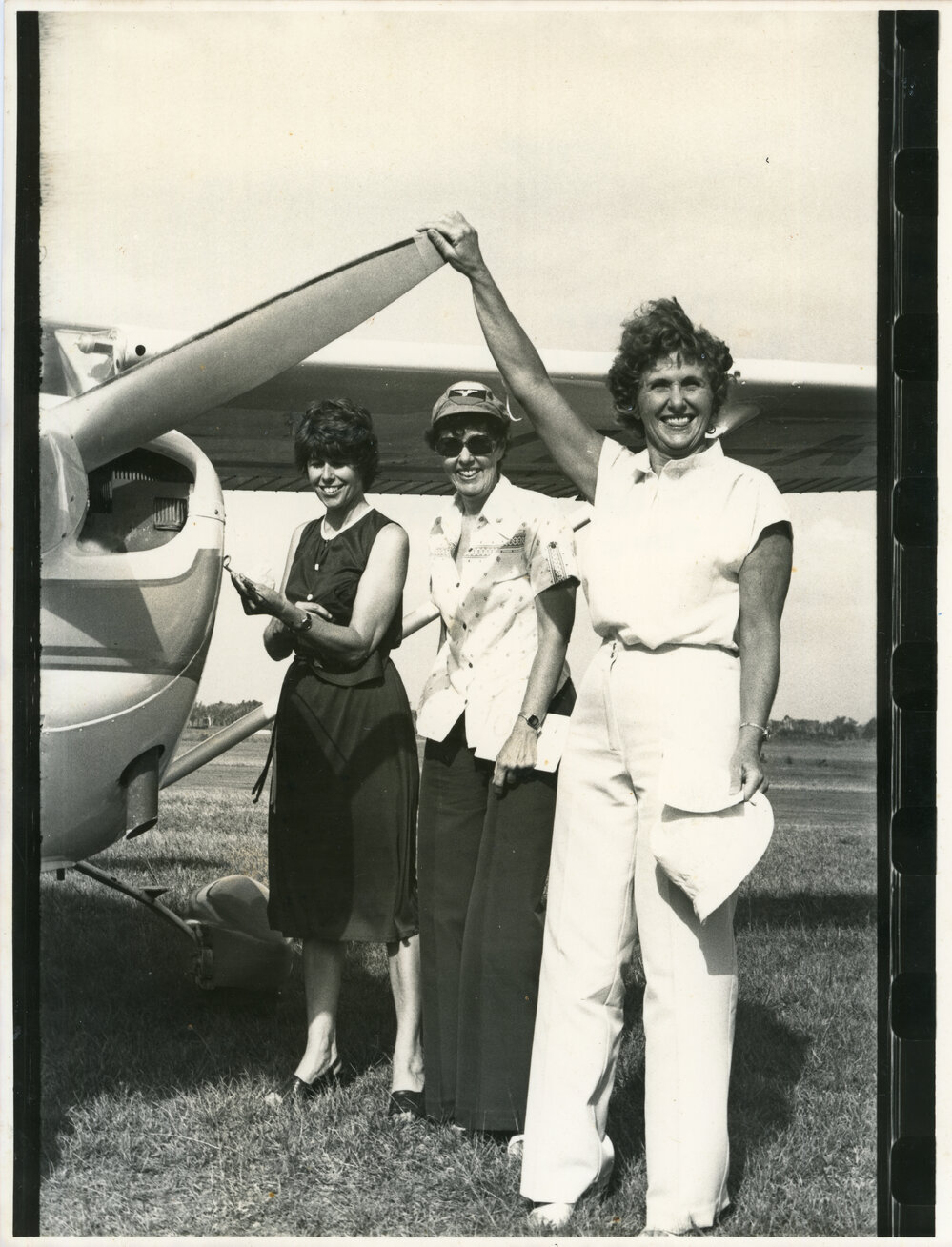 Aviators Judy Riddel and Jean Livesey with Liz Black holding the prop