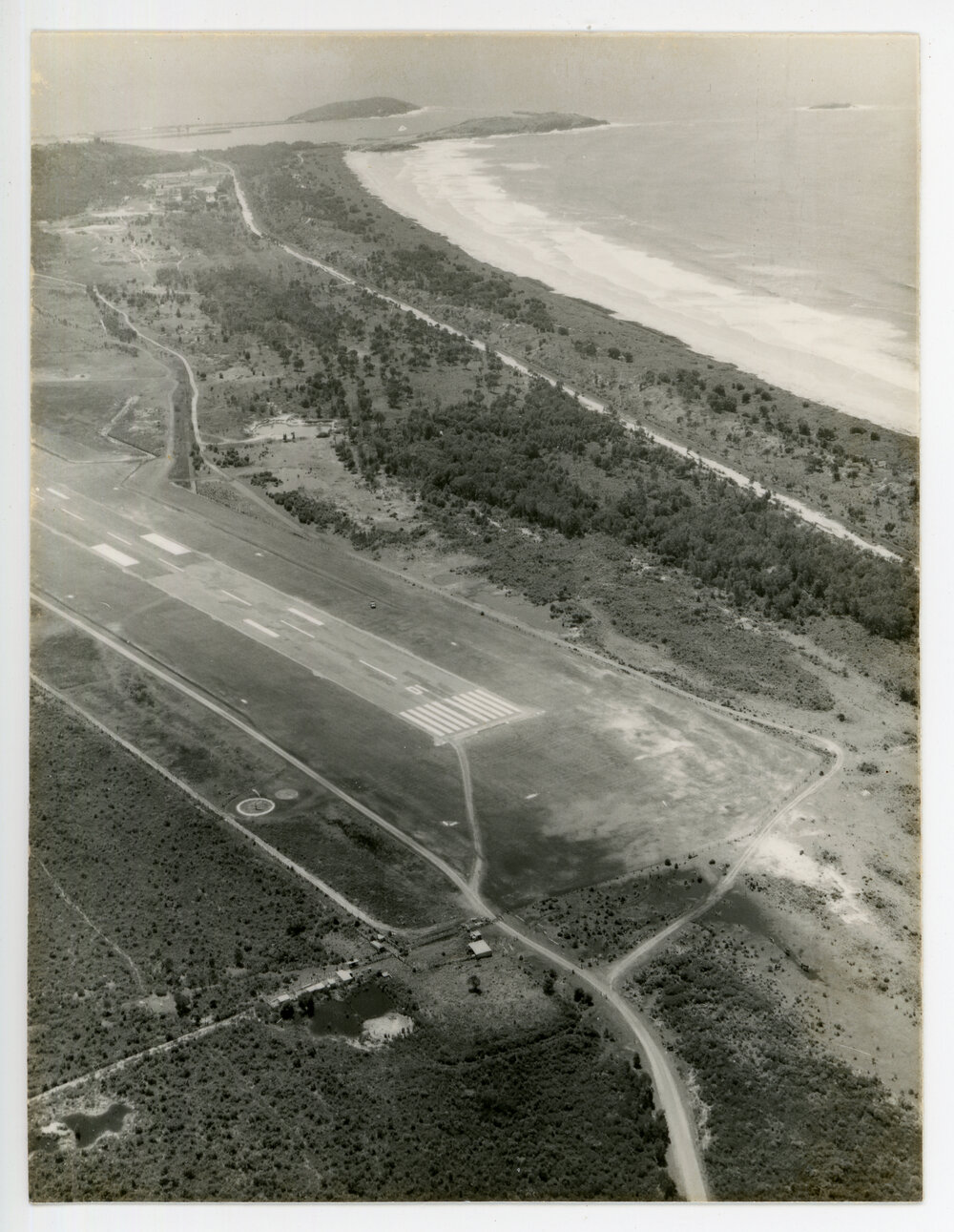 Aerial view of the Coffs Harbour airstrip looking north-east over Corambirra Point, 19 October 1982