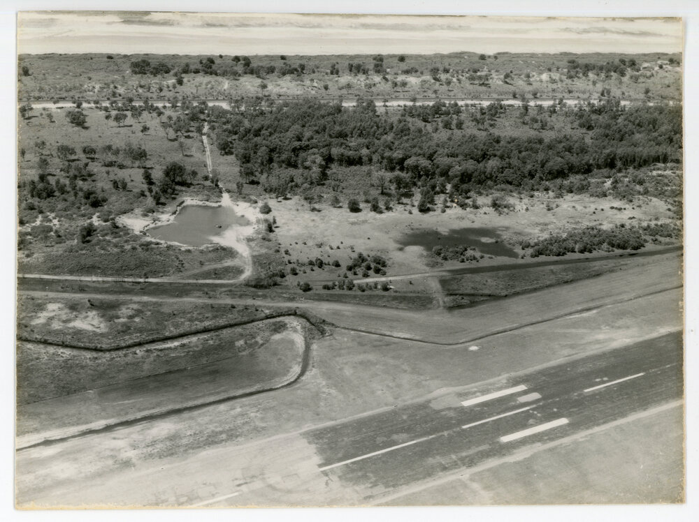 Aerial view of the Coffs Harbour airstrip looking east over Boambee Beach, 19 October 1982