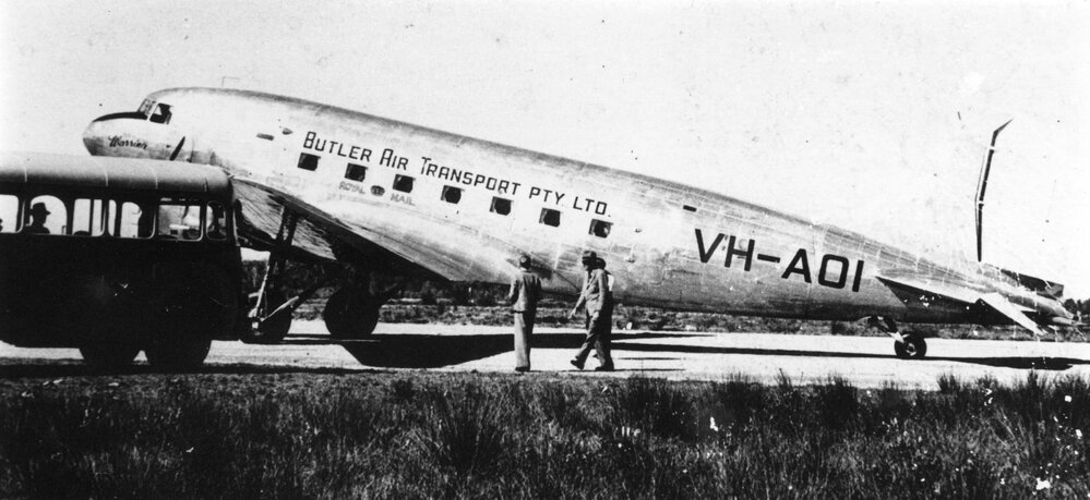 Butlers Air Transport's DC3 Royal Mail plane "Warrina" is met by a town bus