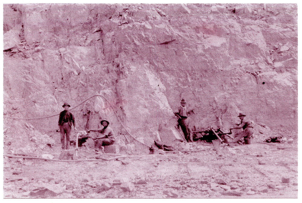 Workmen at the quarry dynamiting rocks for north and south wall construction