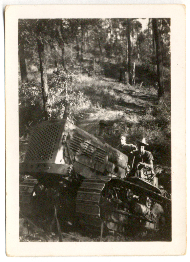 Photograph of two men on a tractor