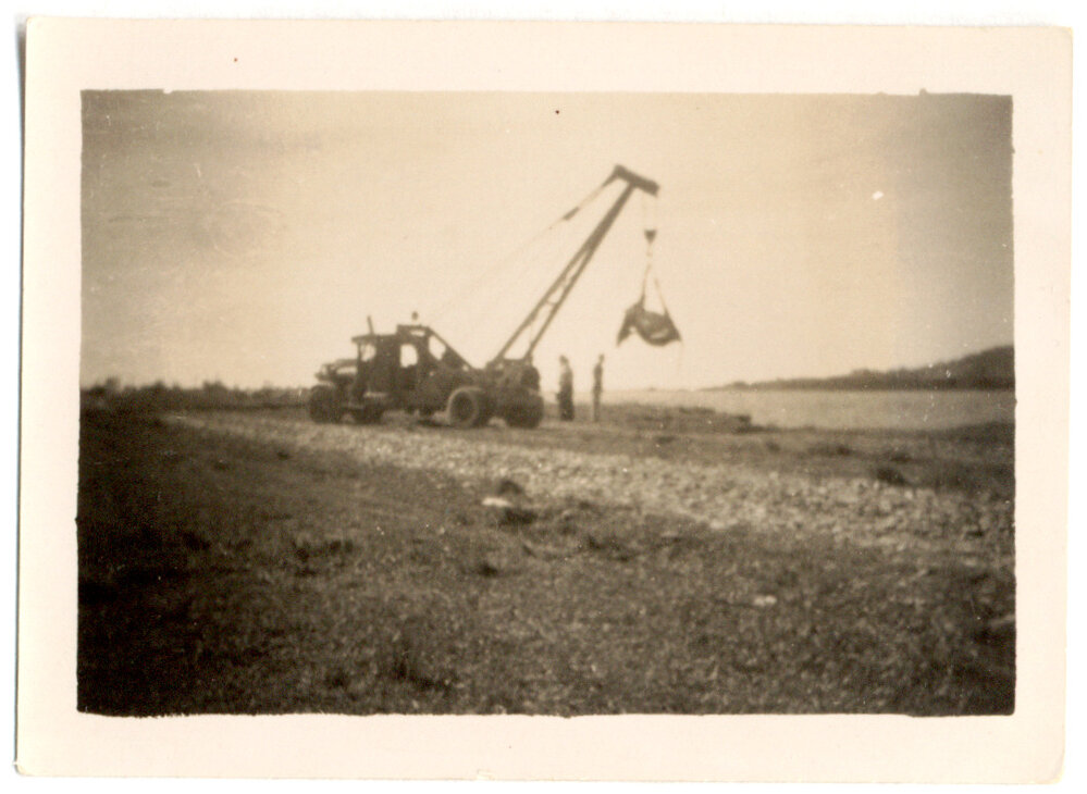 Photograph of two men on a tractor
