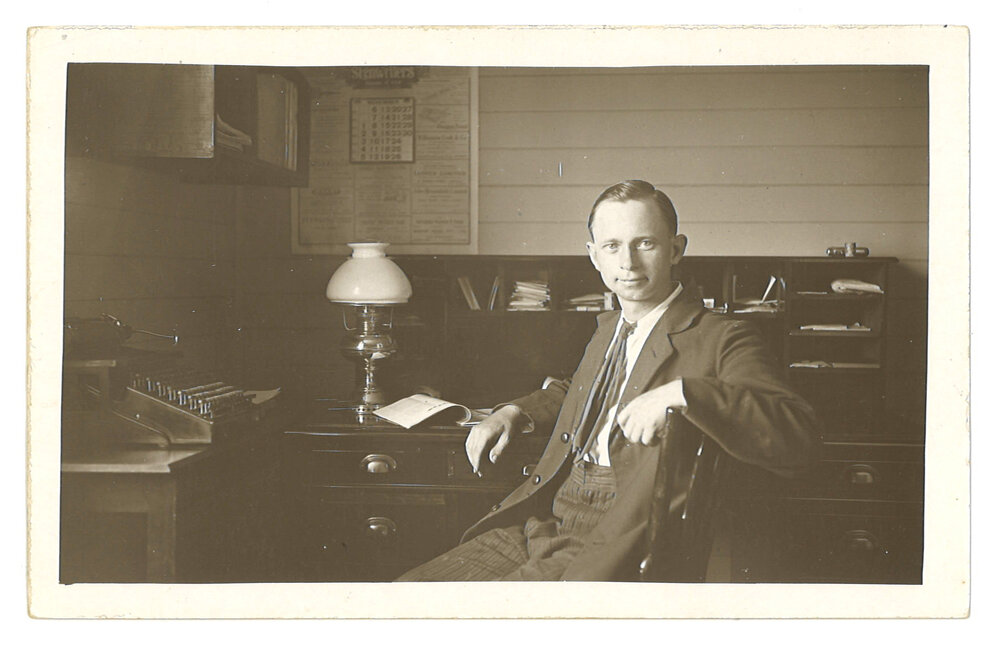 Picture postcard of Peter Jensen at his desk, 1921