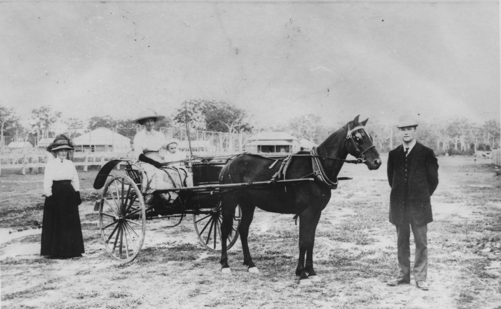 Captain Colvin with two women and a child, c. 1900