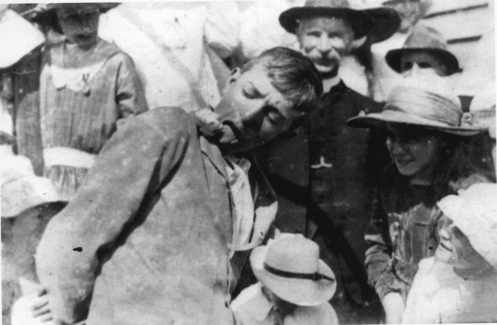 Cecil Jordan competing in the sticky bun eating contest on Empire Day, 1918 