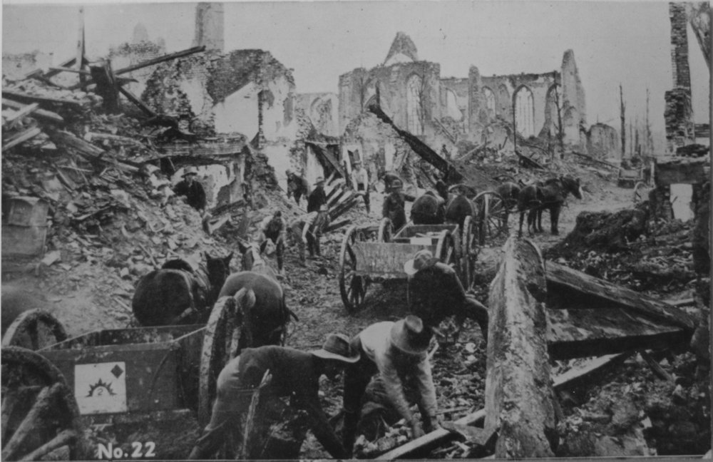 Australian troops clearing a path through a destroyed village, 1917