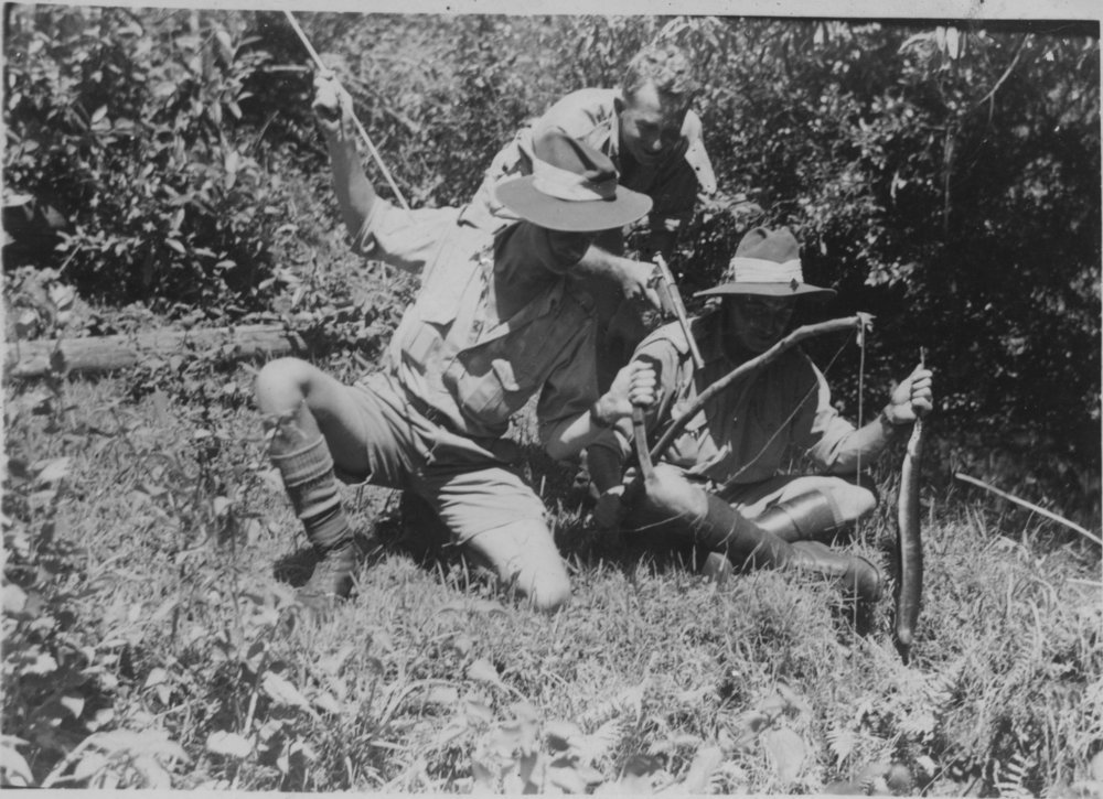 Three soldiers with various weapons, 25 December 1942 
