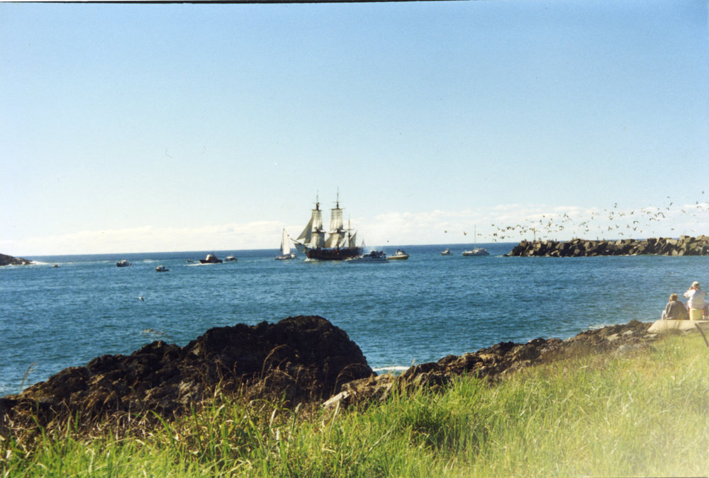 The James Cook's HMB Endeavour replica passing the eastern breakwall to enter the harbour, 1988 