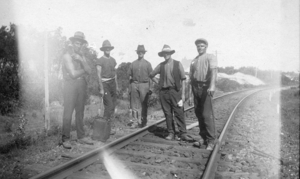 Railway workers standing on the tracks, c.1928 