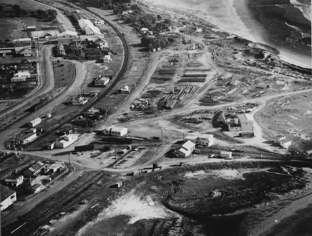 Stacks of timber on the foreshore, 1970 