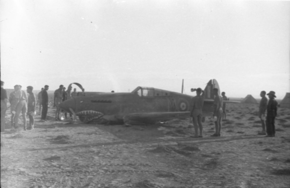 Crewmen surround a crashed Curtis P40 Tomahawk fighter, 1941