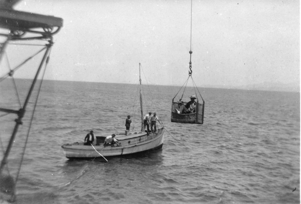 A gantry crane lifts a passenger basket from Platts' launch at South Solitary Island, 11 March 1934 