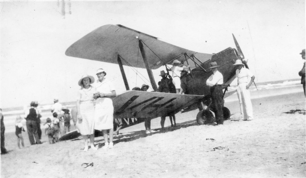 Biplane on Jetty Beach with spectators, 1937