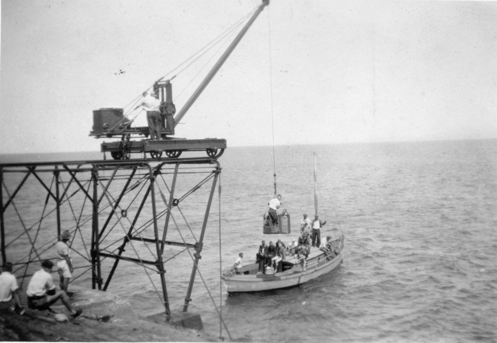 A gantry crane hoists a passenger basket from Alfred Platts' launch at South Solitary Island, 11 March 1934 