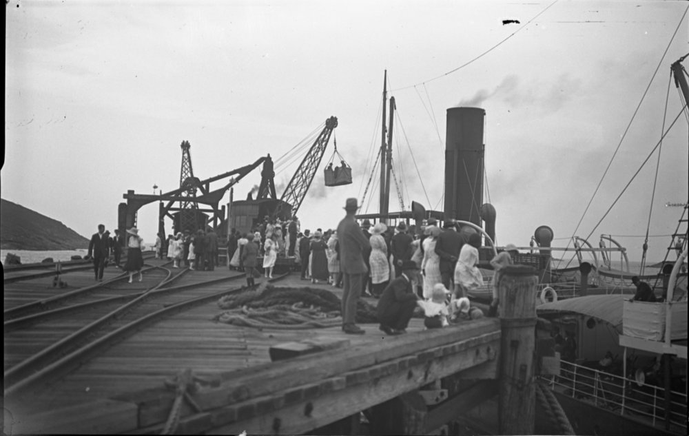 Passengers disembarking in the basket at Coffs Jetty, 19 November 1922