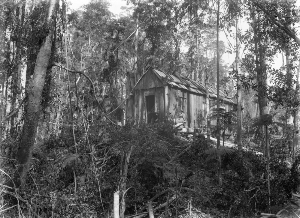 A couple pose in front of a business at the Beacon Mine, c.1898