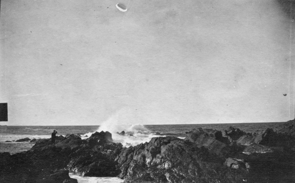 Standing on the rocky point at Moonee Beach, c.1912