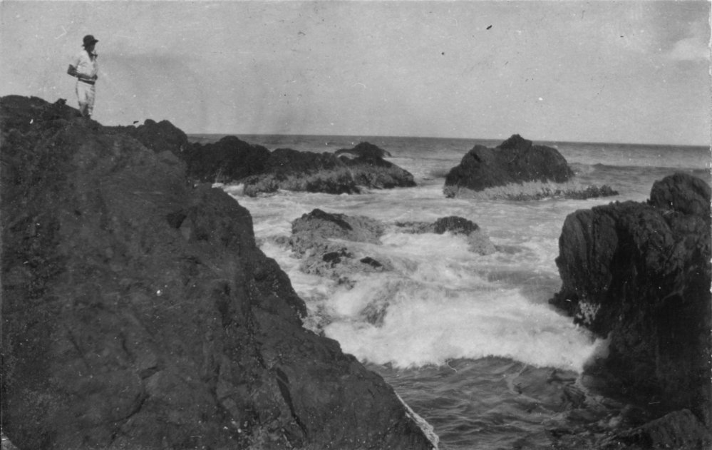 Watching waves break over the rocks, c.1912
