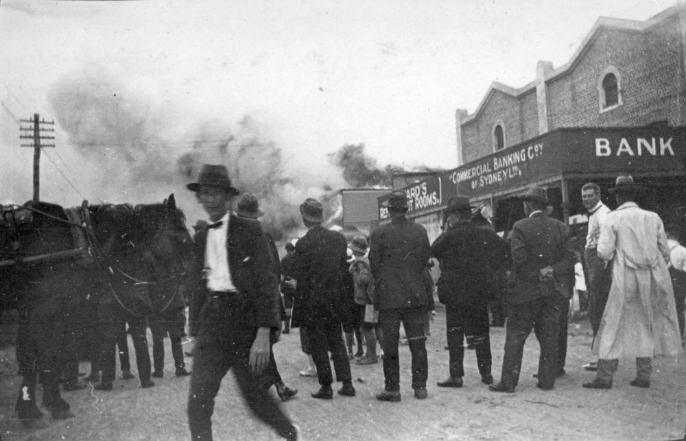 Bystanders watch a building burn down in Byron Bay, c.1912