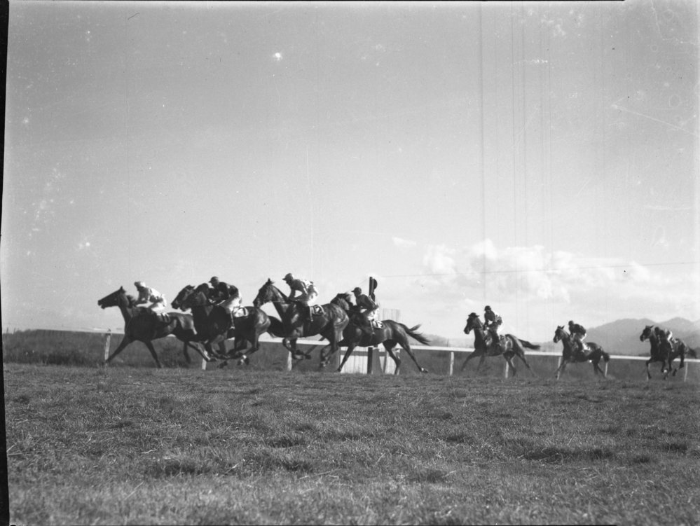 Horses passing the winning post at the Coffs Harbour Racing Club's inaugural meeting, 7 August 1948