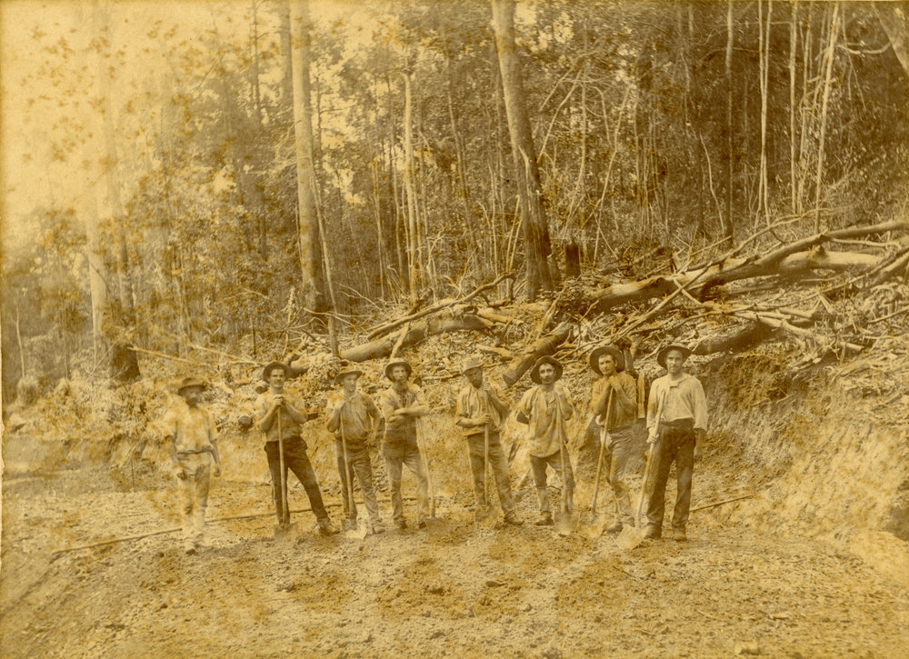 Eight men building a road, c. 1880