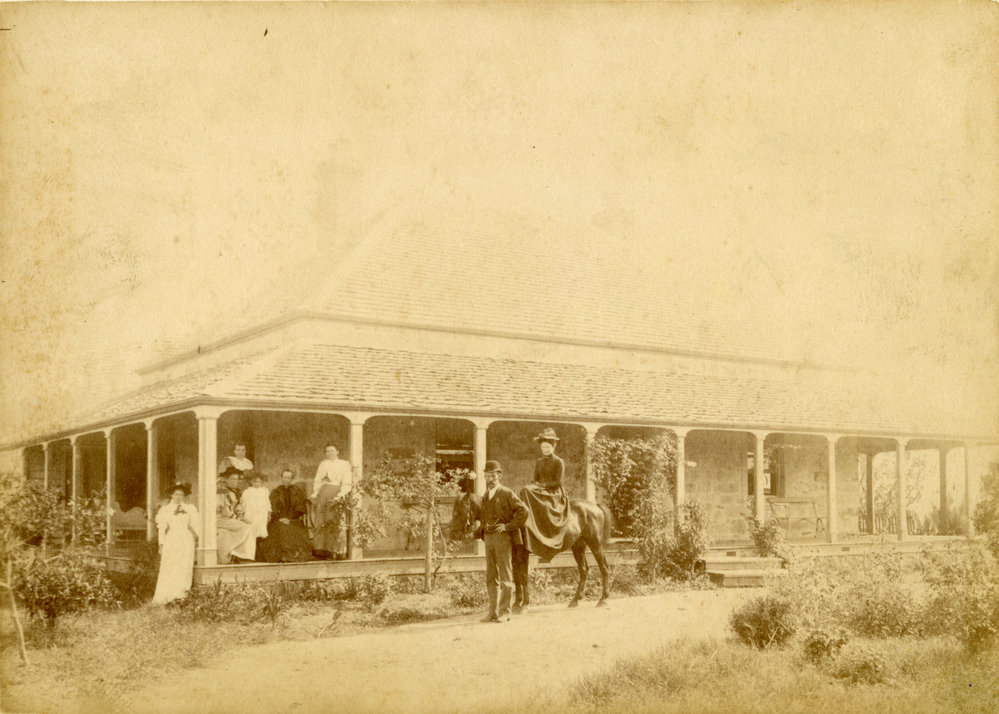 Family on the verandah of a house, c. 1880