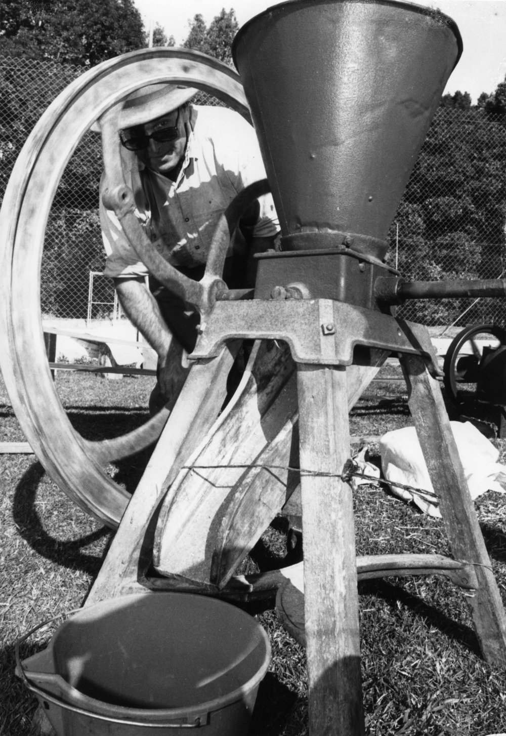 Doug Hoschke demonstrates how to use a corn cracker at the Orara Valley Fair, 10 June 1992 
