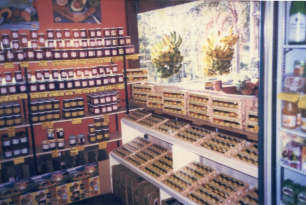 Condiments and bunches of bananas on display at the Tropical Fruit Shop, 1970s