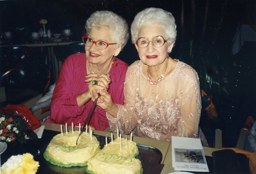 Adelie and Toni cutting their 70th Birthday cake at Sanctuary Cove Resort's Tree House Restaurant, 21 May 1989