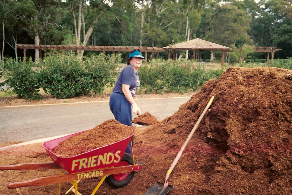 Alice Baker spreading the mulch at the North Coast Regional Botanic Garden
