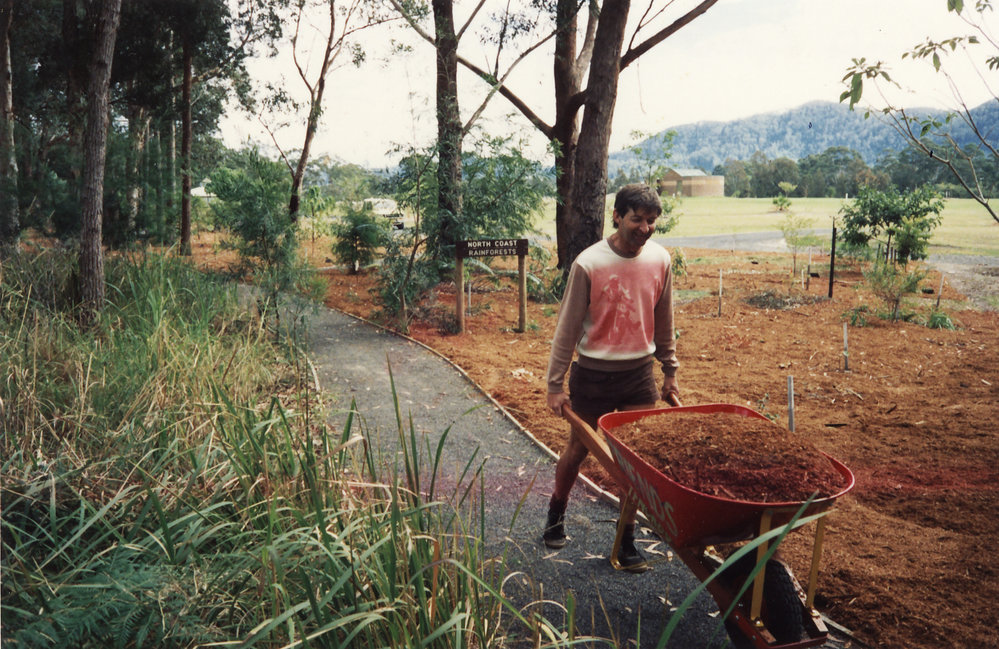 C. England spreading mulch in the rainforest at the North Coast Regional Botanic Garden