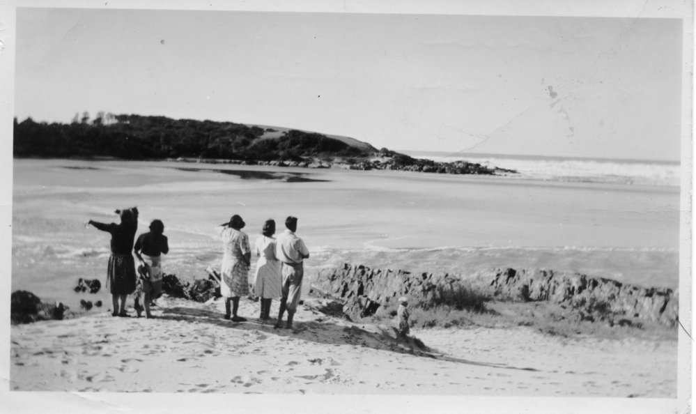 Frank Howe and family observing the rushing outflow at the mouth of Bonville Creek, June 1950 