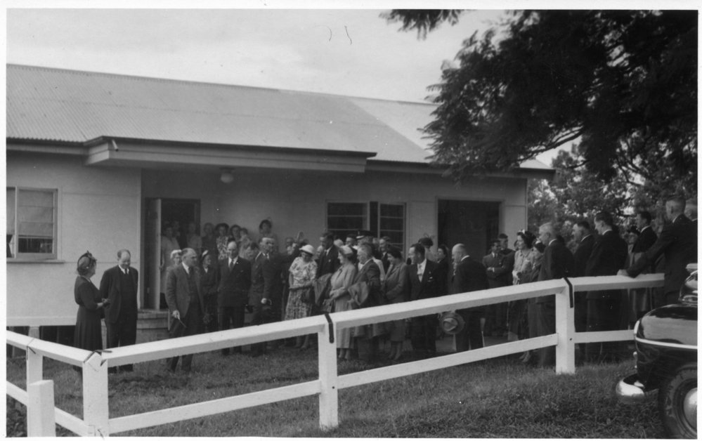 Dr Hewitt plants a tree to open the Country Women's Association at Bellingen