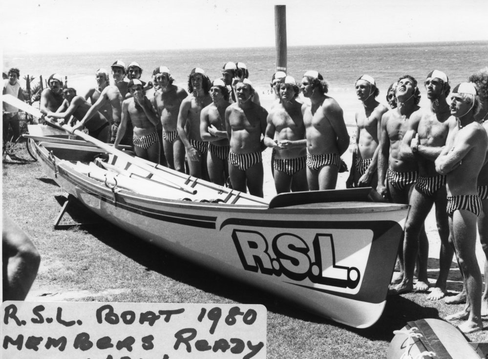 Sawtell Surf Club rowing team standing ready beside R. S. L. boat