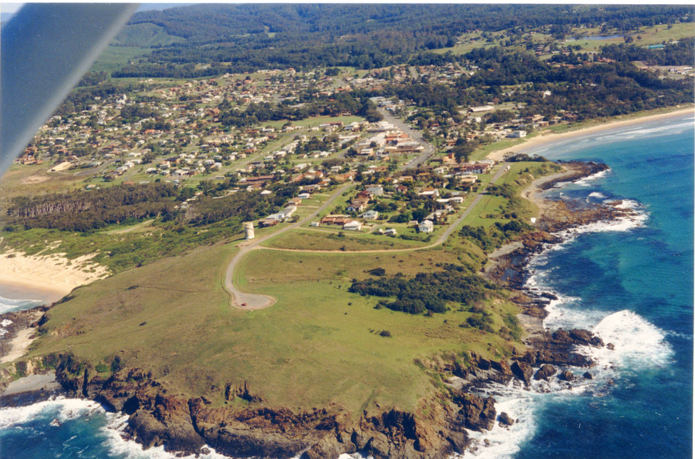Aerial view of Woolgoolga Headland and beaches, 1992-1994 